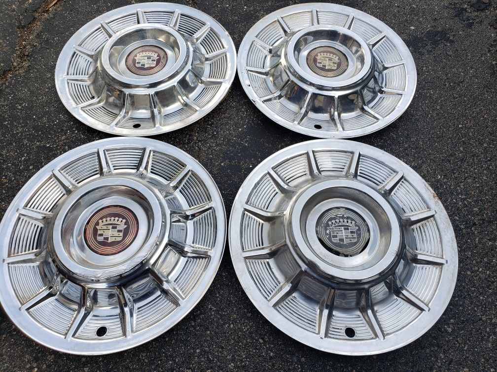Original 1957 Cadillac Hubcaps with 2 good centers. They have some scrapes/dings but a good overall set