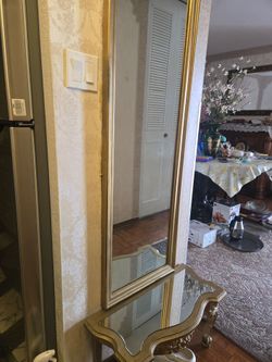 Antique gold trim mirror and table. As a set