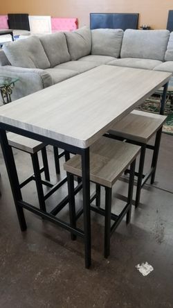 Grey counter height table with 4 stools