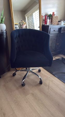 Rolling tufted blue chair with wheels