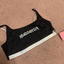 Headbanger black top with a shimmering holographic underband. Scoop neckline and adjustable thin straps for a secure, comfortable fit. Stretch swim fa