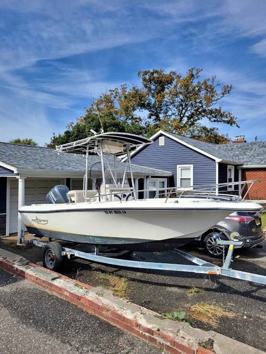  2001 19ft Pro Sport cc with hard top and rocket launchers with home made trailer with registration.