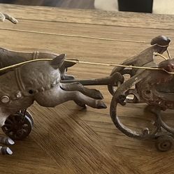 Antique cast iron reindeer pulling Santa in a sled. Toy, Christmas, metal decor