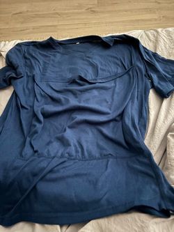 Baby wearing shirt size men’s medium
