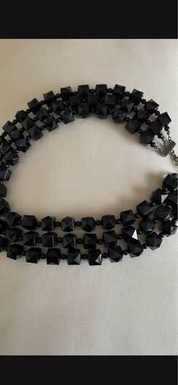 It’s two pieces necklace and bracelet. The color is black.