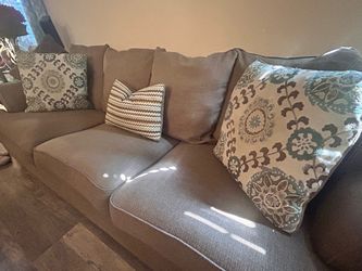 Two Tan Fabric Sofas with Accent Pillows