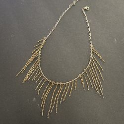 Gold tone fringe necklace
