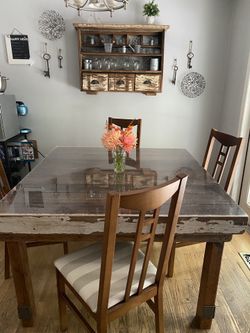 Handmade dining room table and wall cupboard made from reclaimed wood.