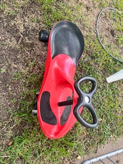 Kids wiggle car / ride-on toy in good used condition. No batteries or pedals needed — just turn the steering wheel back and forth to move.
