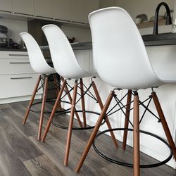 4 Reproduction Eames white molded plastic counter stools with walnut legs