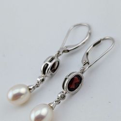 Elegant pair of 14k white gold Garnet, Diamond, and Pearl drop earrings. 