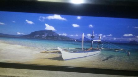 Framed boat on shore photo