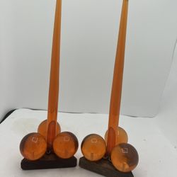 VTG MCM Orange Lucite Candle Holders With Orange Lucite Candles Wood Triangles  This product is a set of two vintage Lucite candle holders from the 19
