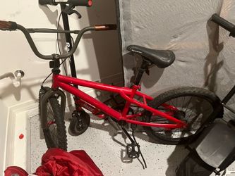 Red bike it has two flat tires