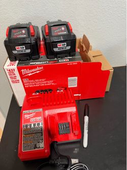 Two batteries and Milwaukee charger 6.0 ah