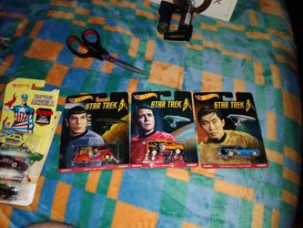 Hot Wheels vehicles from a Star Trek 50th Anniversary series, featuring characters like Spock, Scotty, and Sulu on the packaging.
