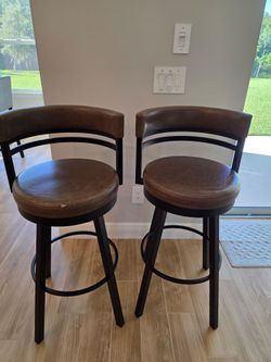 Two Brown Swivel Bar Stools