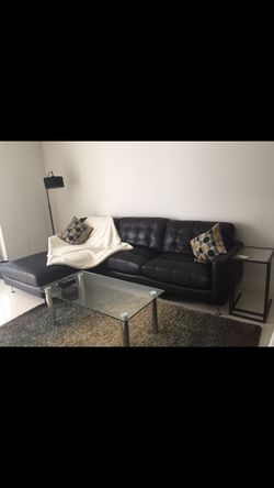 L shaped black sofa (with pillows + throw)