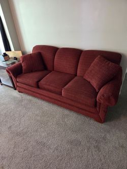 Reddish brown sofa with pillows