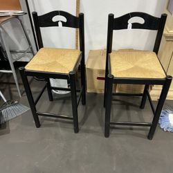 Wooden  chairs with woven seats.