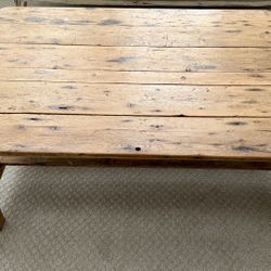 rustic wood coffee table with a slatted bottom shelf.