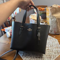 Black coach bag with strap