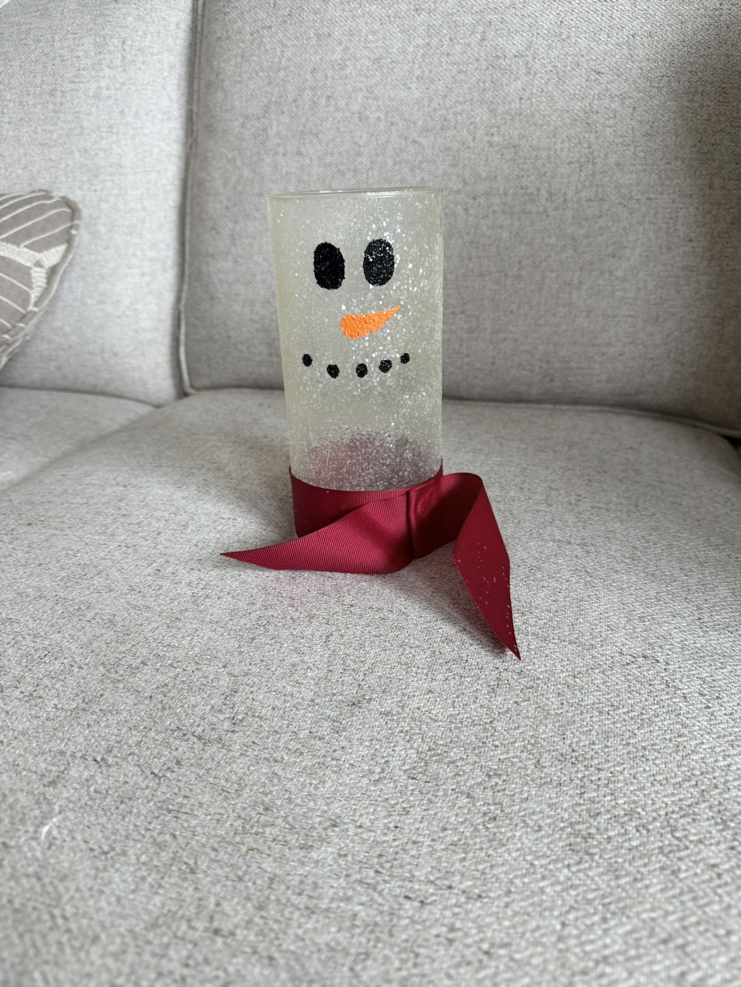 Beautiful snowman-themed glass jar, also referred to as a "Glass Jar Candle Snowman". Popular for holiday or winter decor and can be used with candles