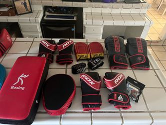 Bench with weights, boxing gloves, punching bag, and mats