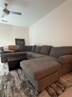 Large Gray Sectional Sofa with Coffee Table and Rug