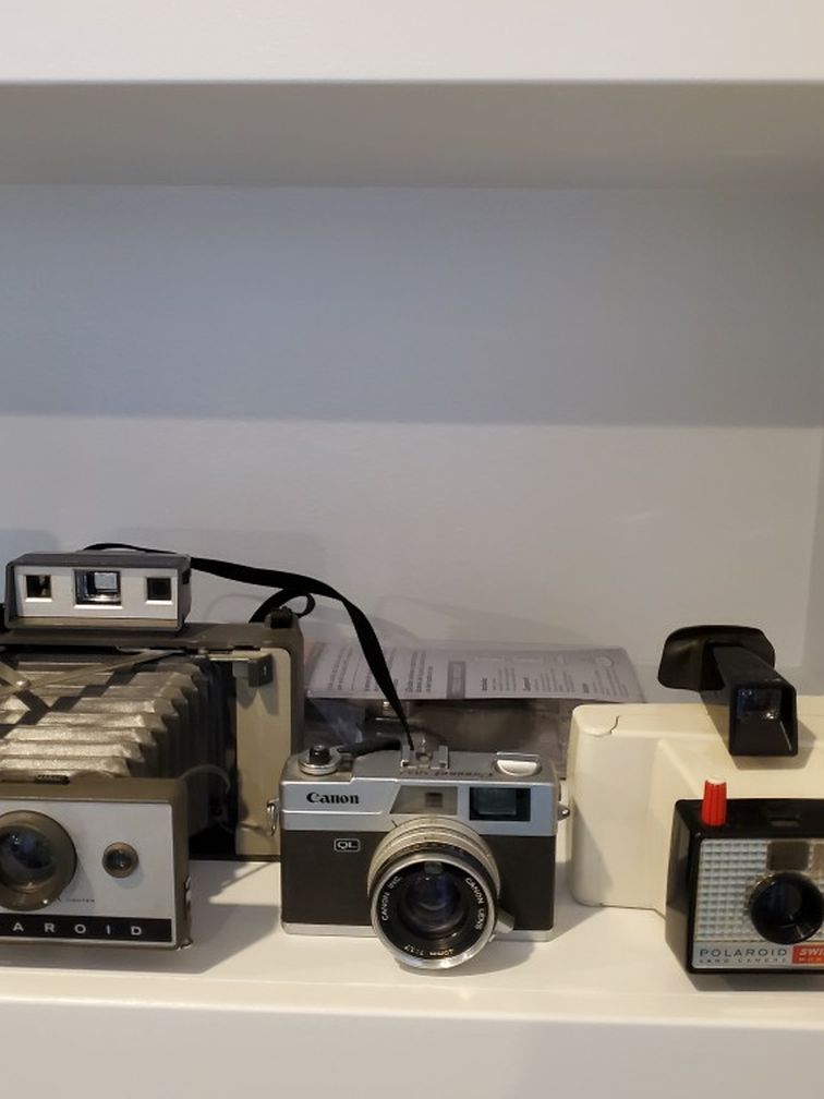 Vintage Polaroid And Canon Cameras And Light Filter