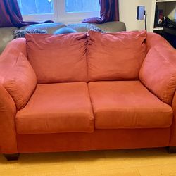 Red fabric loveseat with two protective couch sofa covers included 