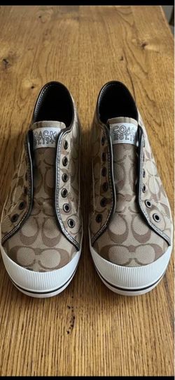 Coach Kira Signature Logo Laceless Sneakers, identified by their signature logo canvas and slip-on