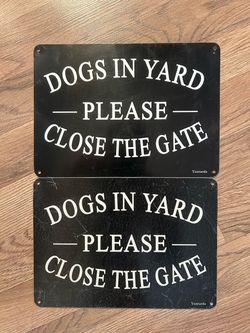 Two metal dog signs