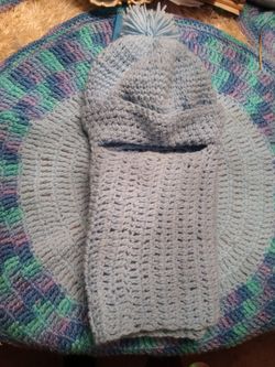 Crocheted hat with attached scarf.