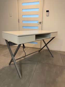 Modern white task desk with hidden power strip