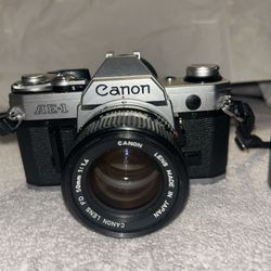 “Canon AE-1 Film Camera with 50mm Lens and 70-150mm Zoom Lens – Fully Functional”