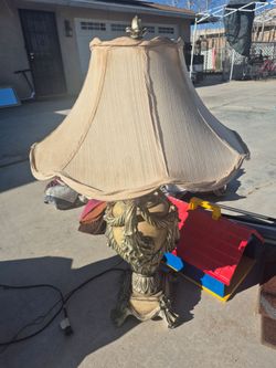 vintage-style table lamp with an ornate, gilded base and a classic fabric shade.