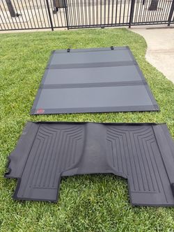 Bed cover and rear floor matt. Came from a 2025 Chevy Silverado 2500