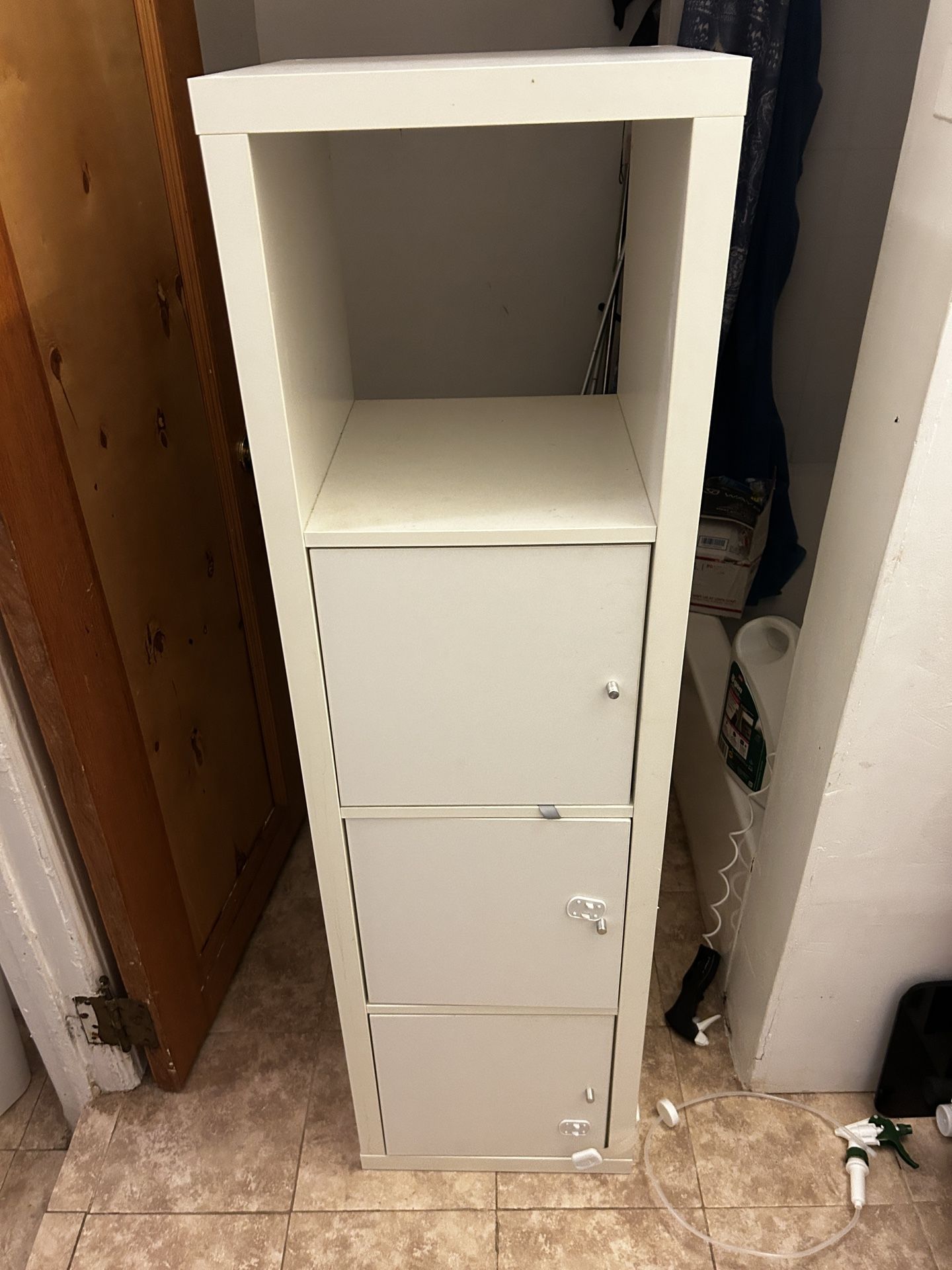 A Three Drawer High Cabinet For The Bathroom White Color