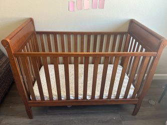 Wooden crib with mattress