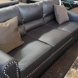 Dark brown traditional pinhead faux leather sofa and loveseat