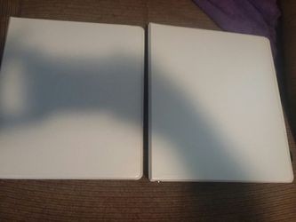 8 white binders and 2 black binders with pockets