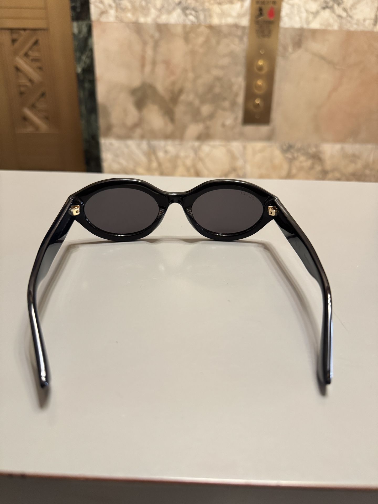 Gucci Oval Shiny Black and Gold Sunglasses display picture 3