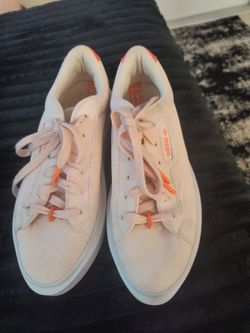 These are light pink Adidas Originals Sleek Super platform sneakers with orange accents and a white sole. Size- 6.5