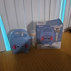 The item shown is a Vivitar Singimals Kids Karaoke Speaker featuring Elliot the Elephant. 
Model: Elliot the Elephant
Features: Includes a wired micro