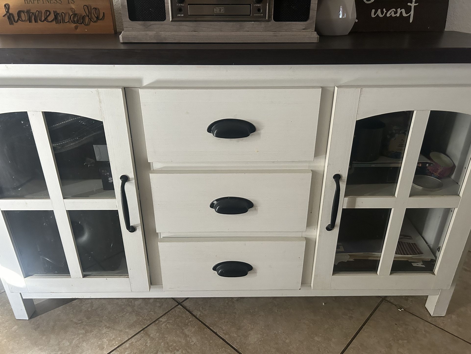 farmhouse-style cabinet in white with a dark wood top.