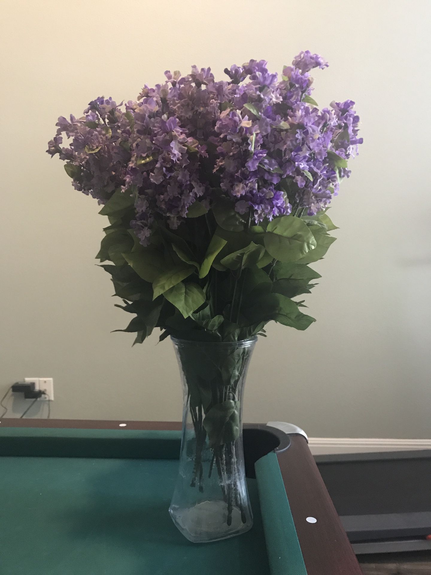 Purple artificial flowers with vase
