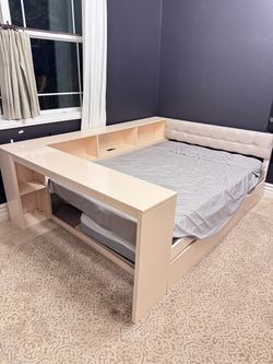 Make an offer. Like new with 2 mattresses. Full size platform bed with trundle, charging station, wood, linen