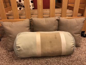 3 taupe pillows and one aqua and cream pillow