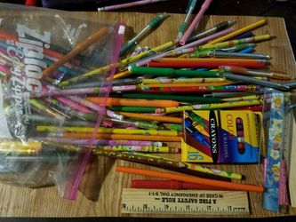 Assortment of pens, pencils, erasers, rulers, crayons, and pencil sharpeners.